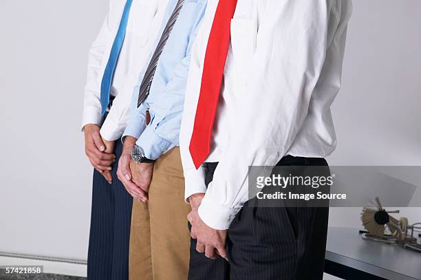 businessmen covering their crotches - male crotch stock pictures, royalty-free photos & images
