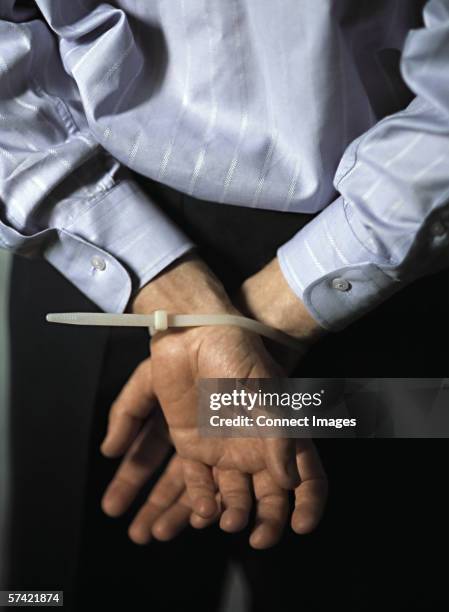 man with hands tied - mãos-atrás-das-costas imagens e fotografias de stock