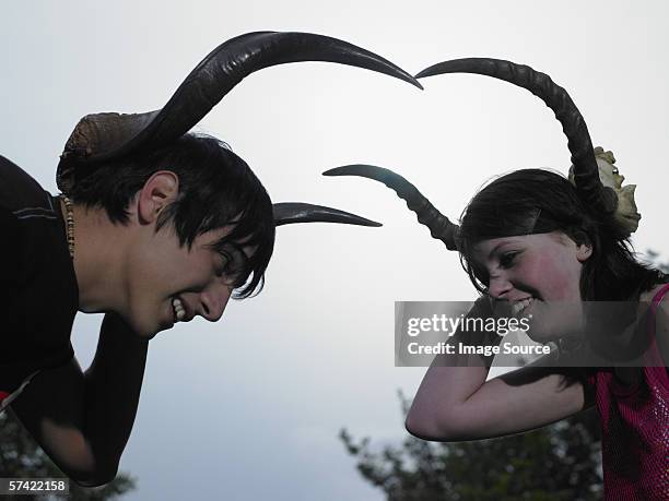 two teenagers holding animal horns - emo stock pictures, royalty-free photos & images