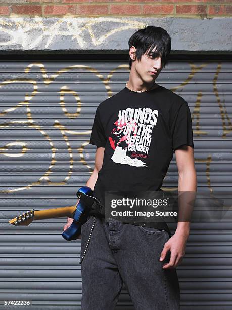 teenage boy holding guitar - one teenage boy only stock pictures, royalty-free photos & images