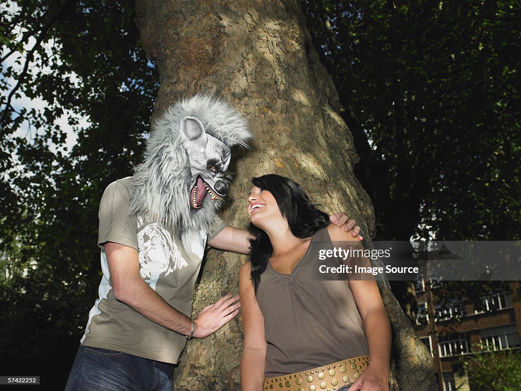 Young couple playing with Halloween mask