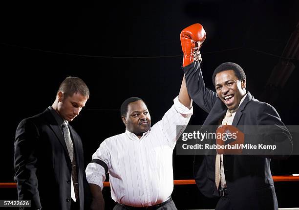 referee declaring the winner of a boxing match - super excited suit stock pictures, royalty-free photos & images