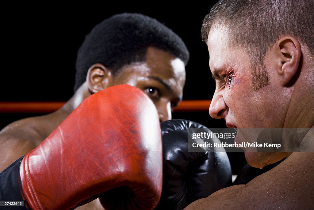 Close-up of two young men fighting in a boxing ring