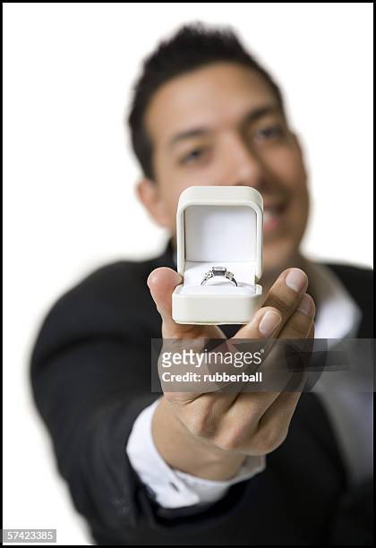 portrait of a young man holding a jewelry box - engagement ring box 個照片及圖片檔