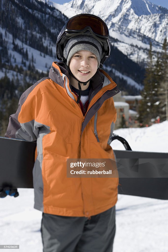Portrait of a boy holding a ski