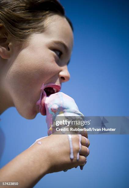 profile of a girl eating an ice-cream cone - girl eating messy ice cream cone stock-fotos und bilder