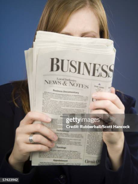 close-up of an adult woman reading a newspaper - escrita ocidental imagens e fotografias de stock