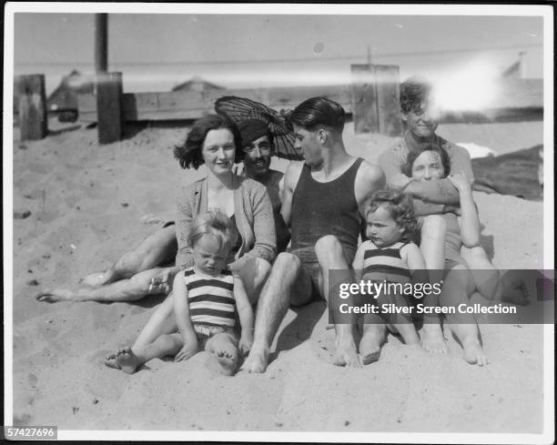 Norma Jeane Baker future film star Marilyn Monroe , on the beach as a toddler with her mother Gladys Baker and a group of friends, circa 1929.