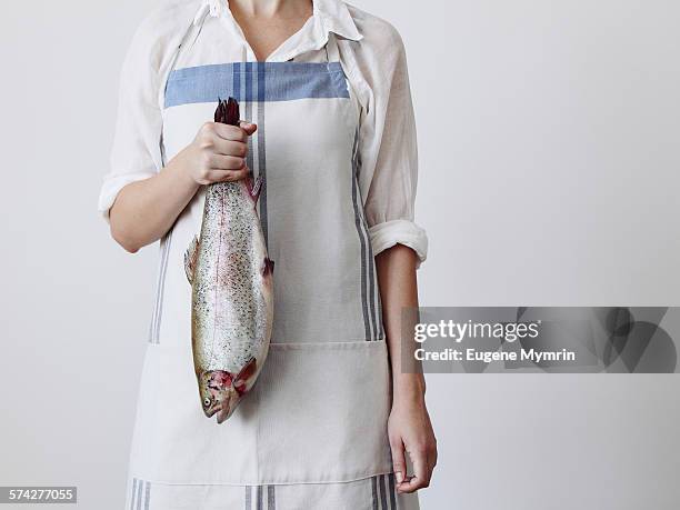 young woman holding a fish - trout stock pictures, royalty-free photos & images