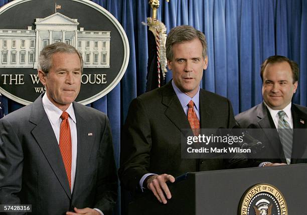 President George W. Bush listens to Tony Snow speak at the podium after Bush announced that Snow will replace Scott McClellan as the new White House...
