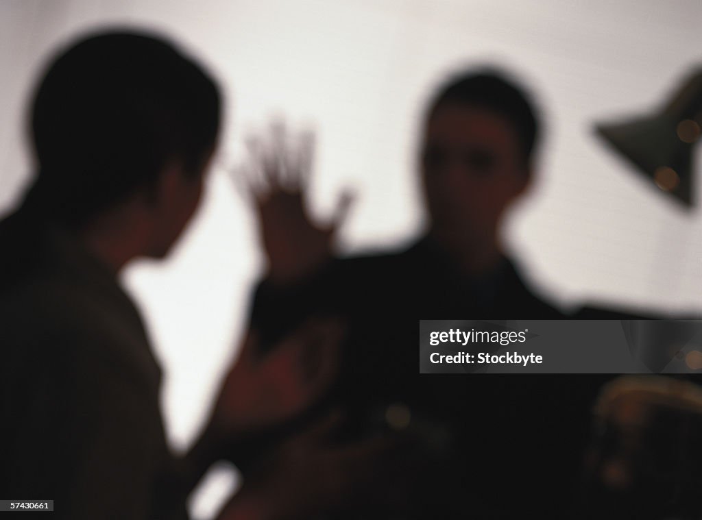 Silhouette of two business executives talking