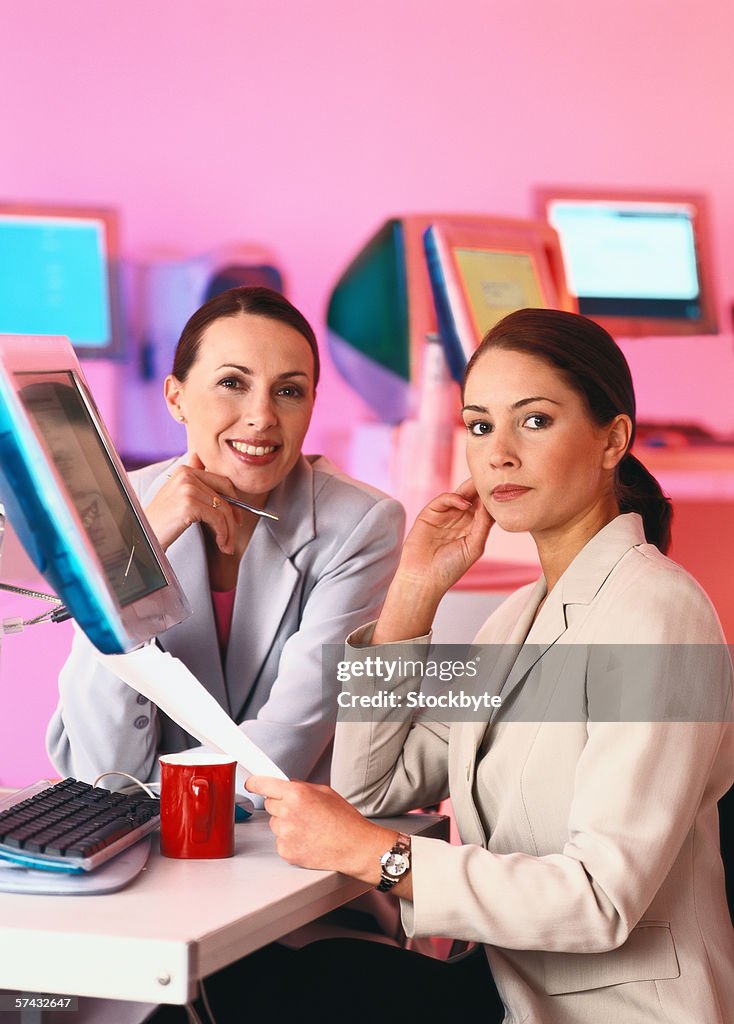 Portrait of two young businesswomen looking at camera