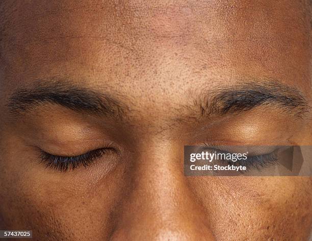 close-up of a man's eyes shut - eyes closed stock pictures, royalty-free photos & images