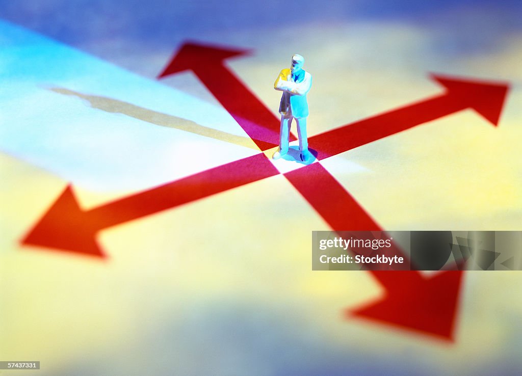 High angle view of a man's figure standing on a cross of arrows