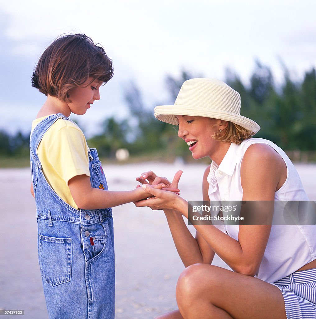 Side profile of a mother talking to her daughter on the beach