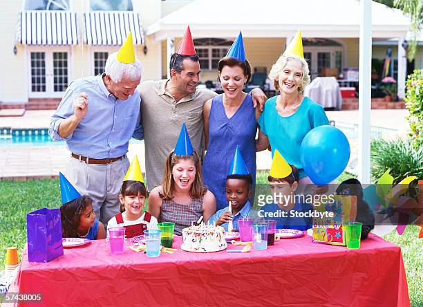 view of a three generational family celebrating a birthday - mamma bambina palloncino bianco foto e immagini stock