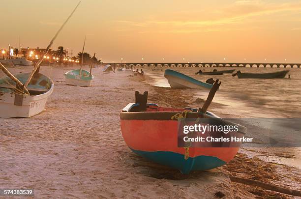 fishing boats on beach sunset yucatan, mexico - barca a remi foto e immagini stock