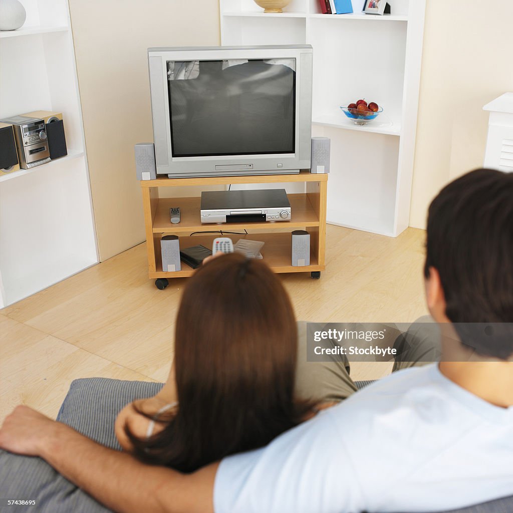 Rear view of a couple watching tv