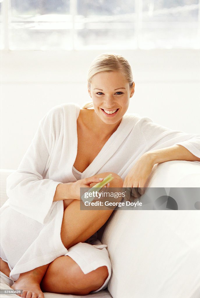 Sitting Robe Portrait Of A Woman Sitting In A Robe On A Couch Smiling High-Res Stock ...