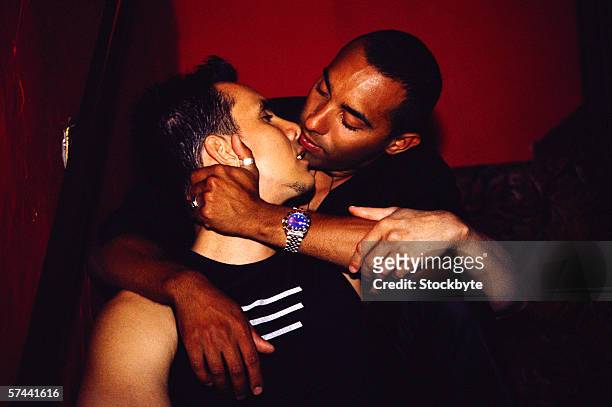 a young gay couple holding each other about to kiss - black people kissing stock pictures, royalty-free photos & images