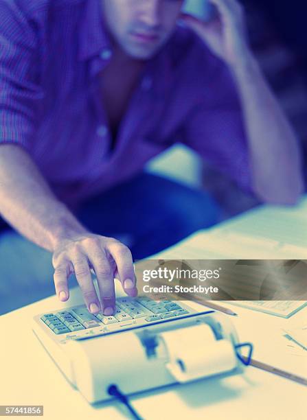 Man Ringing Up Adding Machine Toned Shot Of A Man Using A Adding Machine High-Res Stock Photo - Getty ...