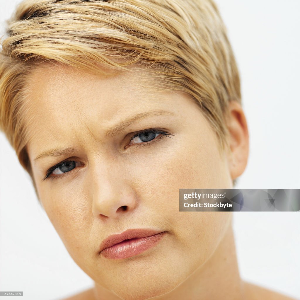 Portrait of a young woman frowning