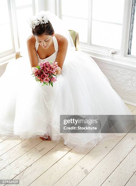 portrait of a bride sitting with a bouquet of flowers - impatience flowers stock pictures, royalty-free photos & images