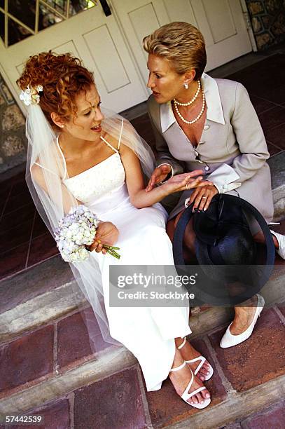 view of a bride and her mother sitting on steps - nervous bride stock pictures, royalty-free photos & images