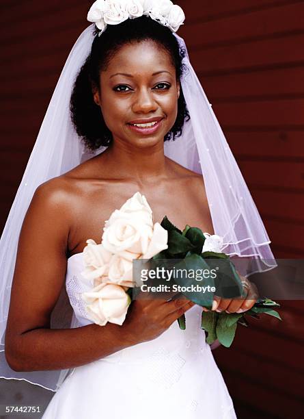 portrait of a bride holding a bouquet of white roses - single rose ストックフォトと画像