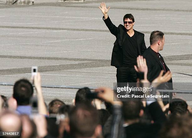 American Actor Tom Cruise waves as he arrives to attend the Mission: Impossible III French Premiere on April 26, 2006 in La Defense, outside Paris,...