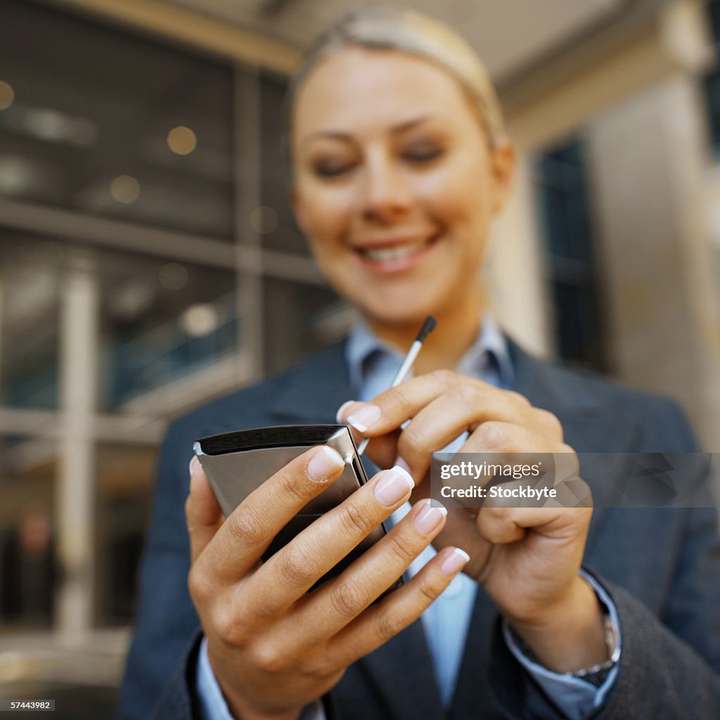 Low angle view of a businesswoman using a PDA