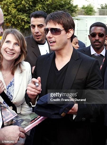 American actor Tom Cruise signs autographs for fans after arriving at the "Mission: Impossible III" French Premiere on April 26, 2006 in La Defense,...