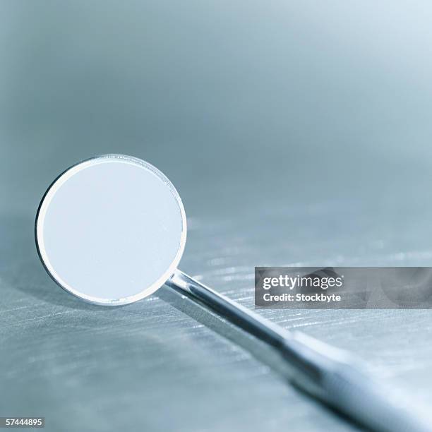 a dentist's angled mirror - espejo dental fotografías e imágenes de stock