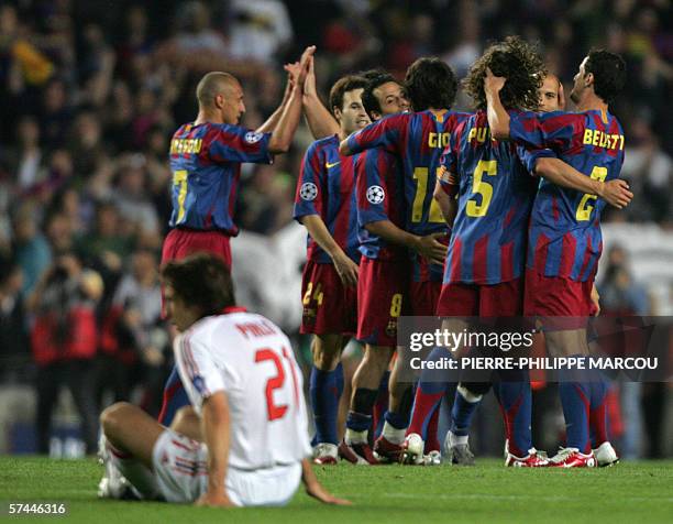 The Barcelona team celebrate after drawing with AC Milan in their Champions League semi-final second leg football match at the Camp Nou stadium in...