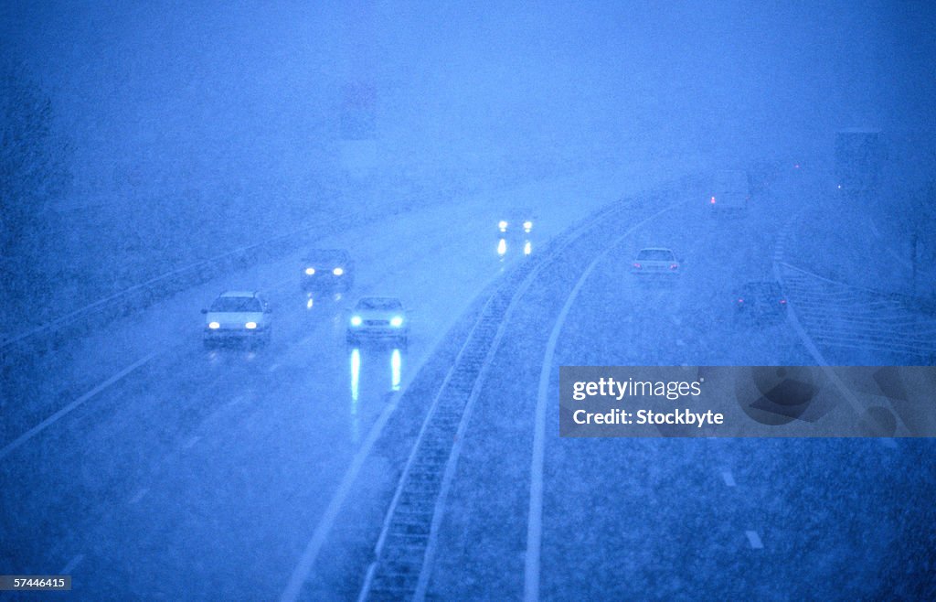 Tungsten toned high angle view of cars on a freeway driving in fog