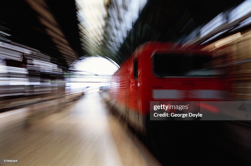 Blurred view of a train pulling into a subway station