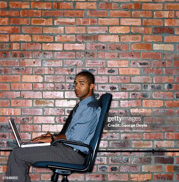 Side Profile Of A Man Sitting And Working On A Laptop Computer High-Res ...