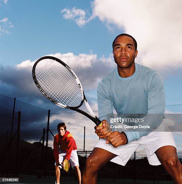 low angle view of a man playing a game of tennis - tennis court and low angle stock-fotos und bilder