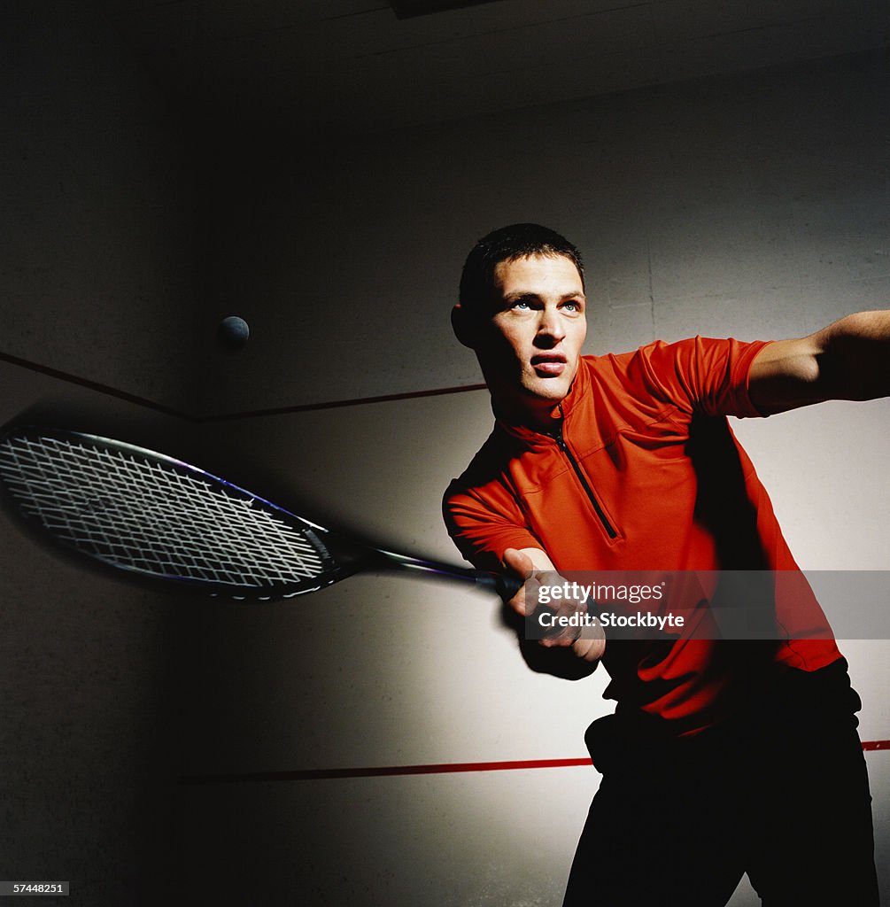 Low angle close-up of a man hitting a shot in a game of tennis