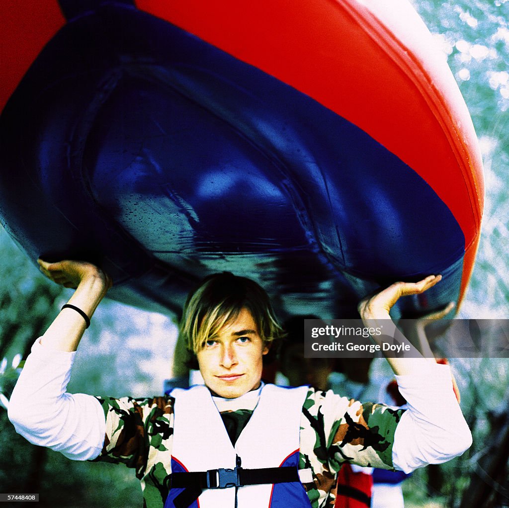 Guy On Inflatable Raft Young Man Carrying An Inflatable Raft Over His Head High-Res Stock ...