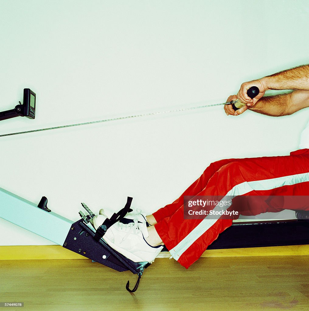 Side profile close-up of the legs of a man on an exercise machine