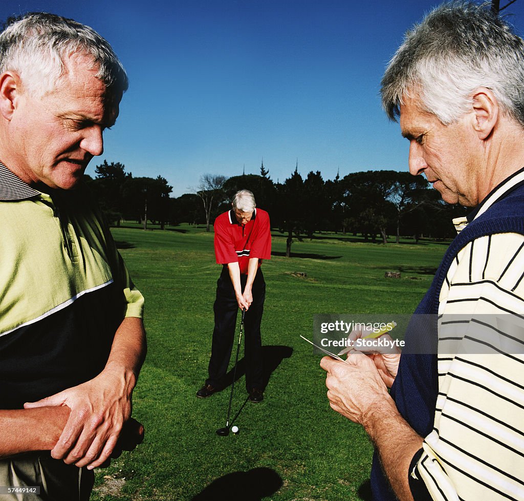 Close-up of elderly men talking at a golf course