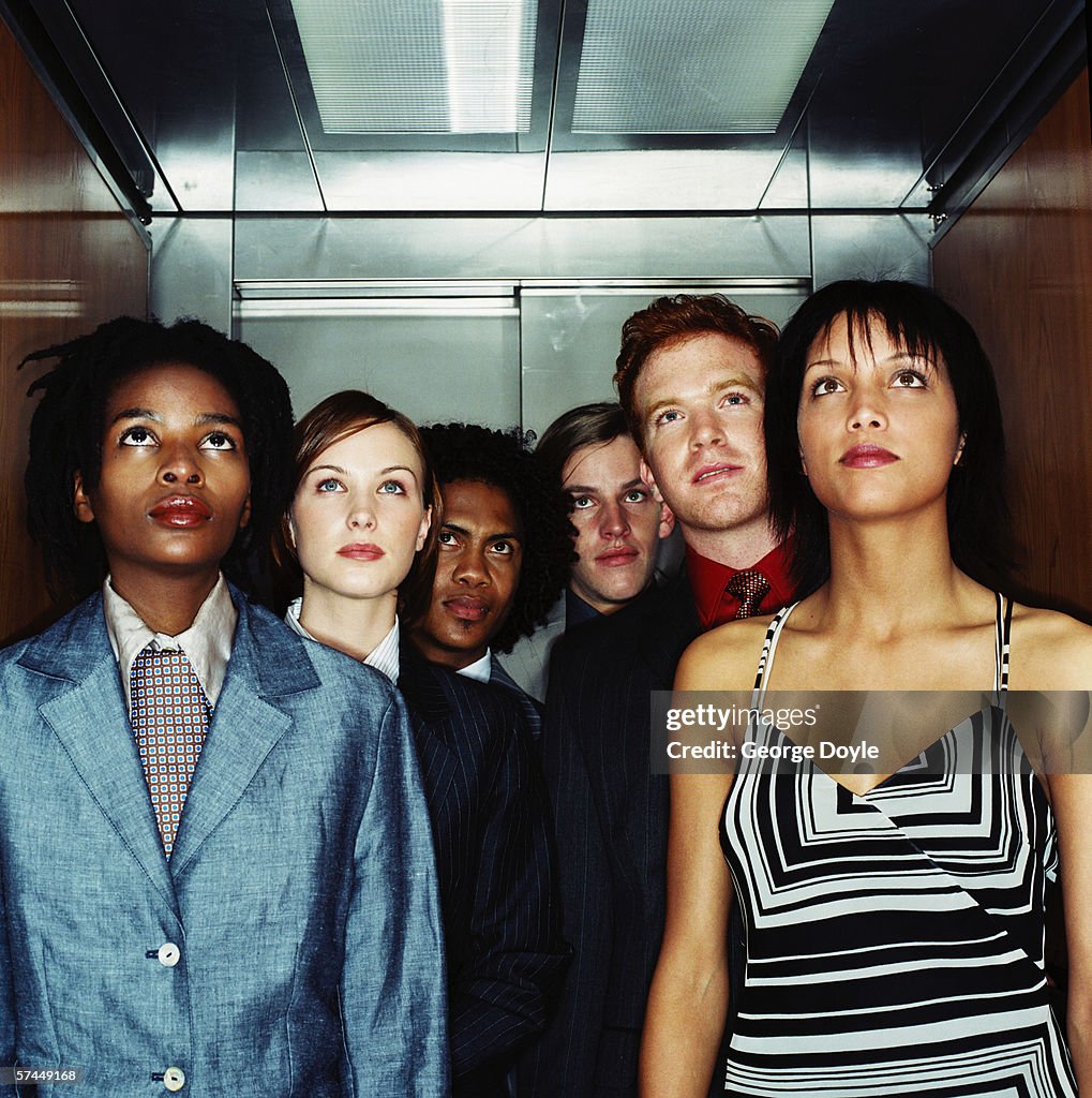 View of a people looking at the floor display in an elevator