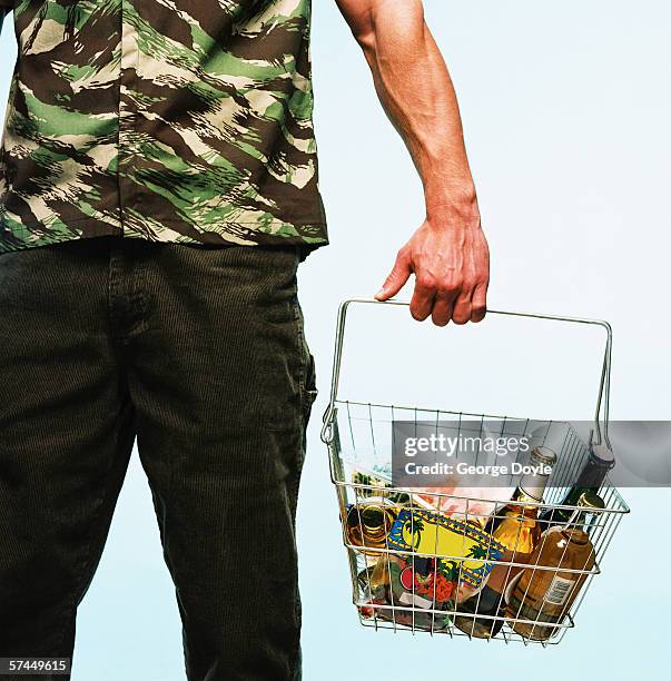 view of a man standing with goods in a shopping basket - buying beer stock-fotos und bilder