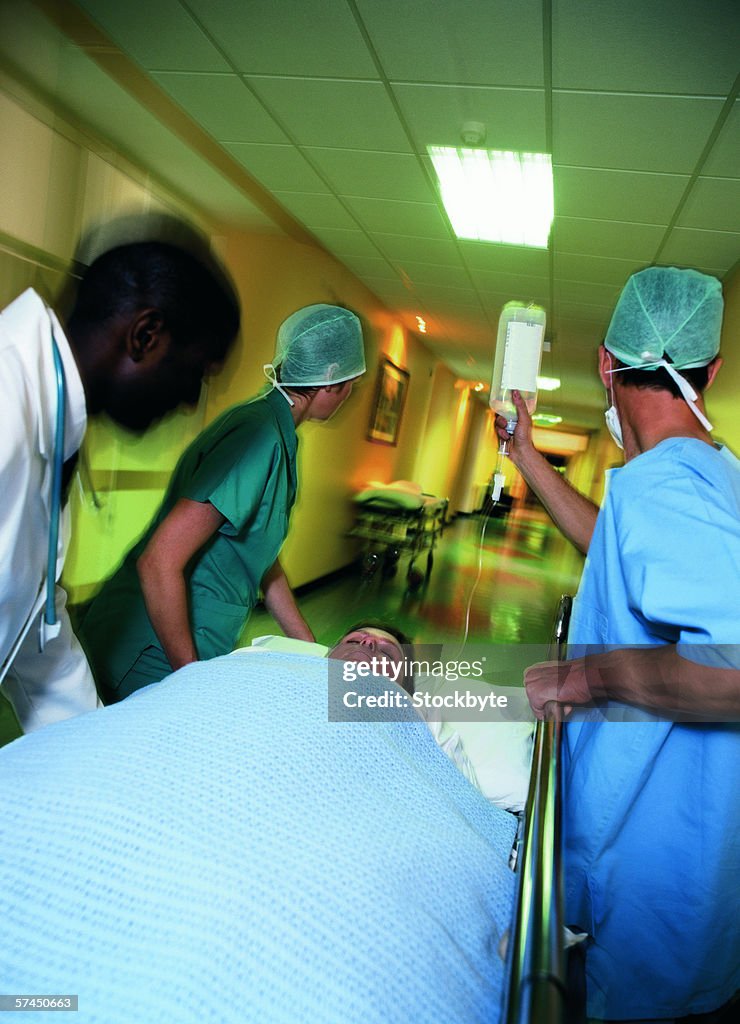 Medical personnel rushing a patient on a gurney in the hospital