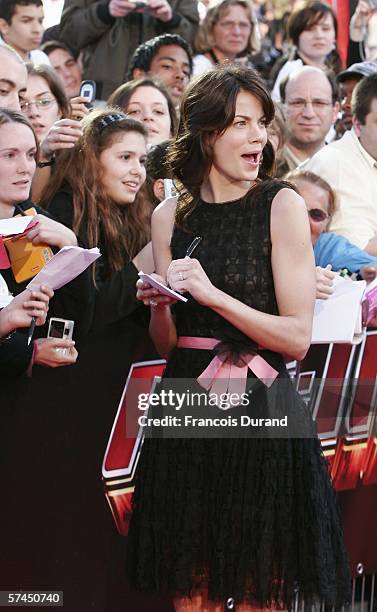 American actress Michelle Monaghan signs autographs for fans after arriving at the "Mission: Impossible III" French Premiere on April 26, 2006 in La...