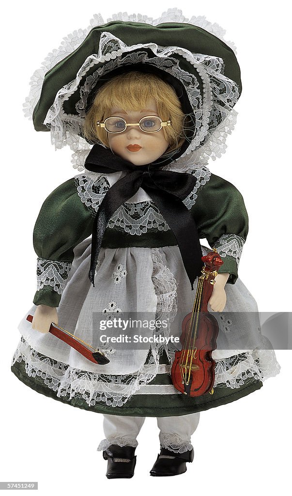 Female doll holding a violin