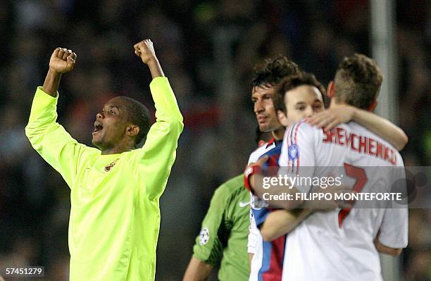 Barcelona's Cameroonian Samuel Eto'o celebrates as teammate Ludovic Giuly comforts AC Milan's Andrij Shevchenko at the end of the Champions League...