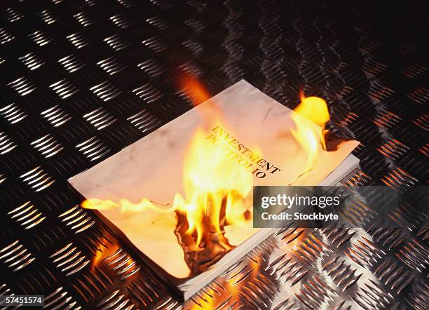 elevated view of a book burning on a metal surface - autodafé de livres photos et images de collection