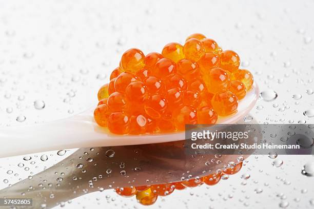 trout caviar in spoon - red caviar stock pictures, royalty-free photos & images
